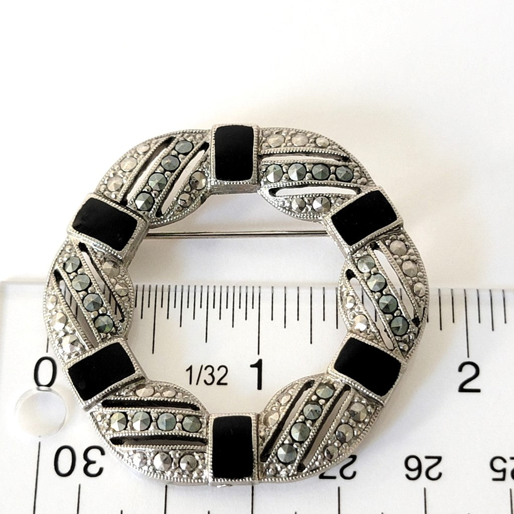 1928 enamel brooch with ruler.
