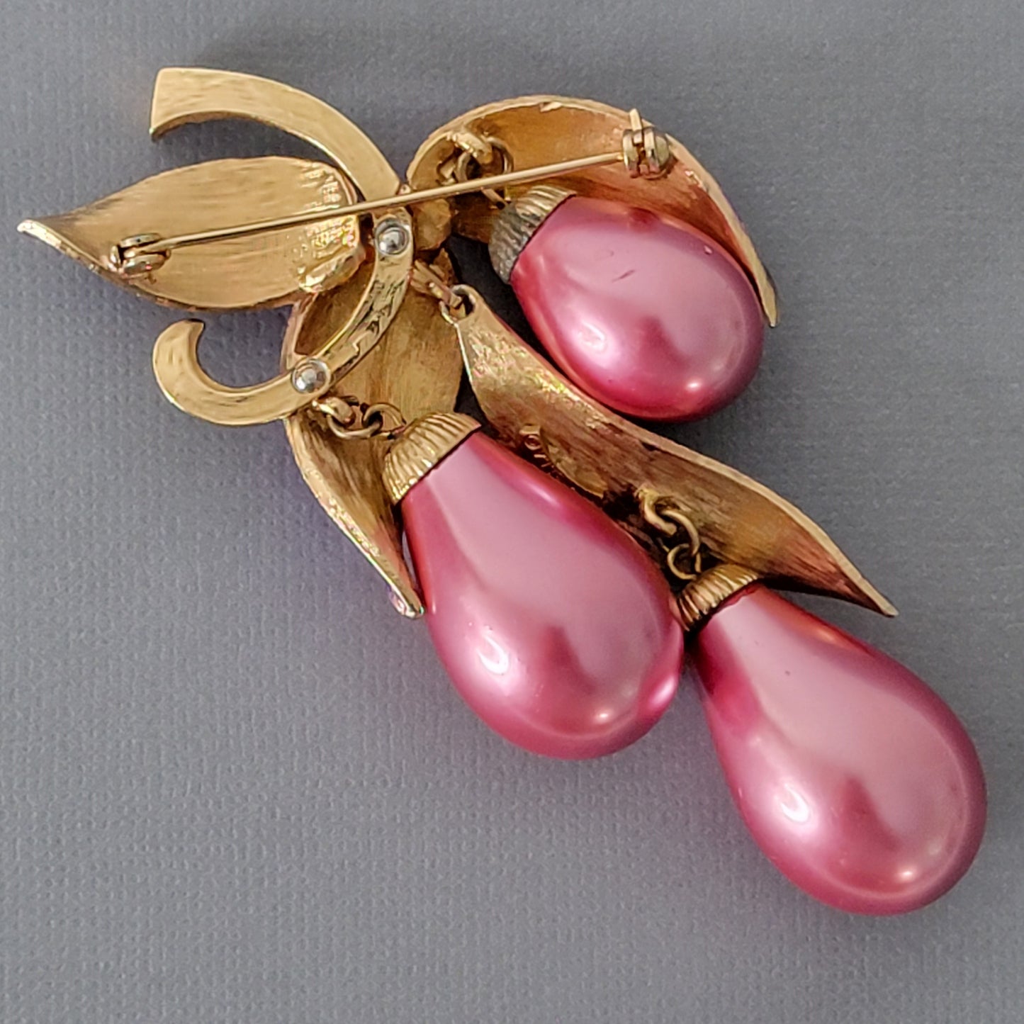 Back of a vintage beaded dangle brooch.