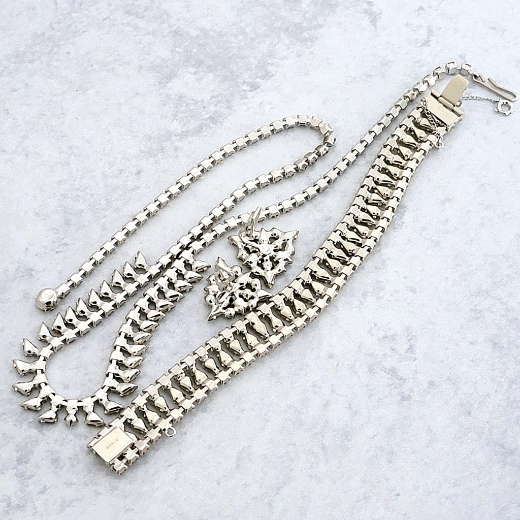 Back of a vintage jewelry set in silver rhodium tone.