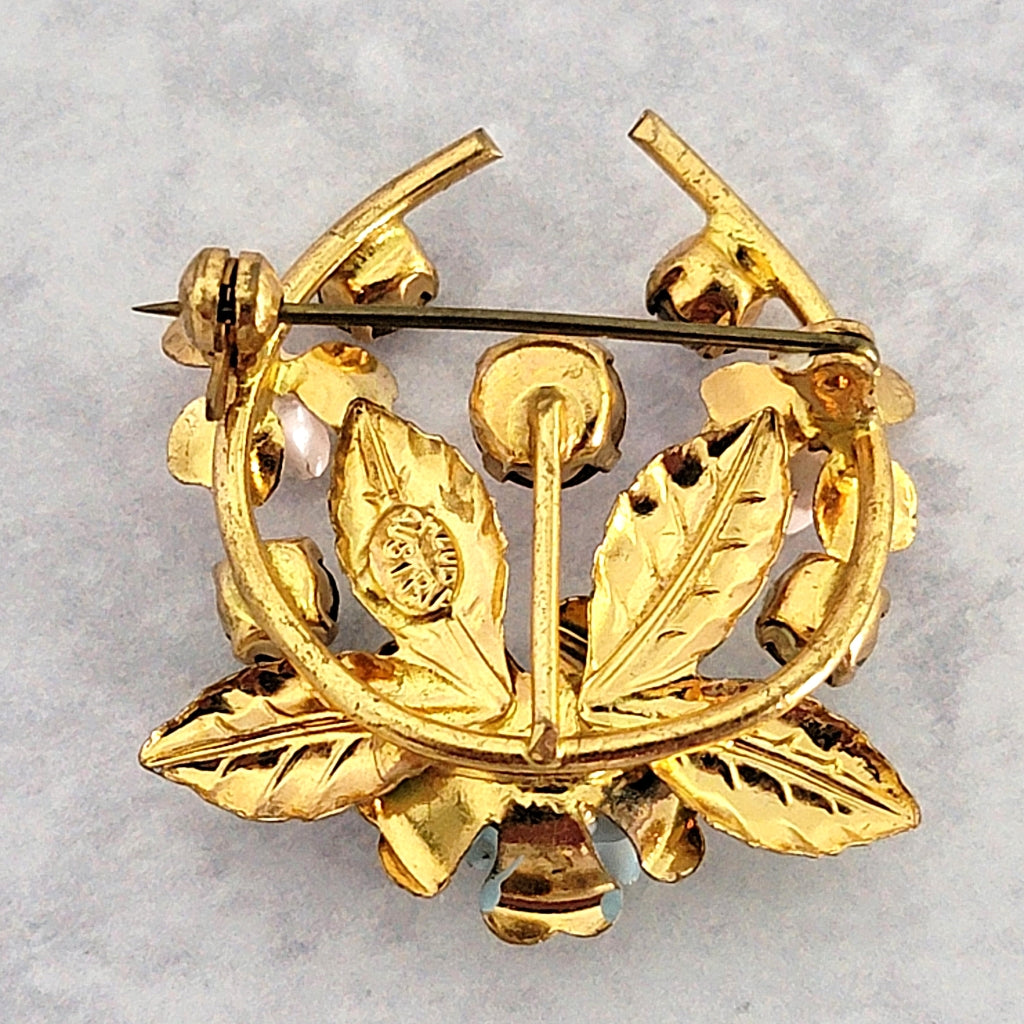 Vintage pin back with clasp.