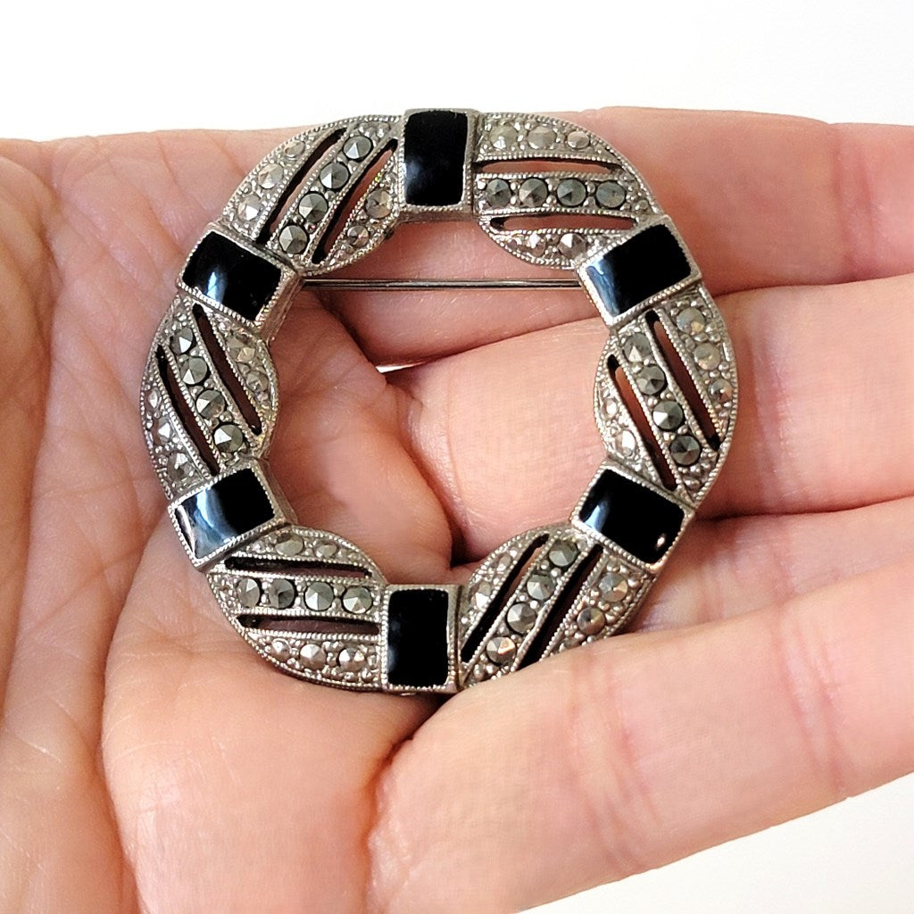 Goth style vintage brooch in hand.
