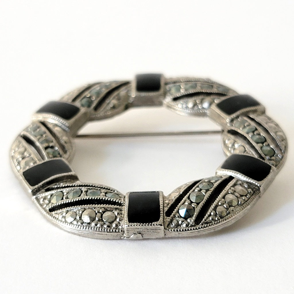 Bottom of black enamel brooch.