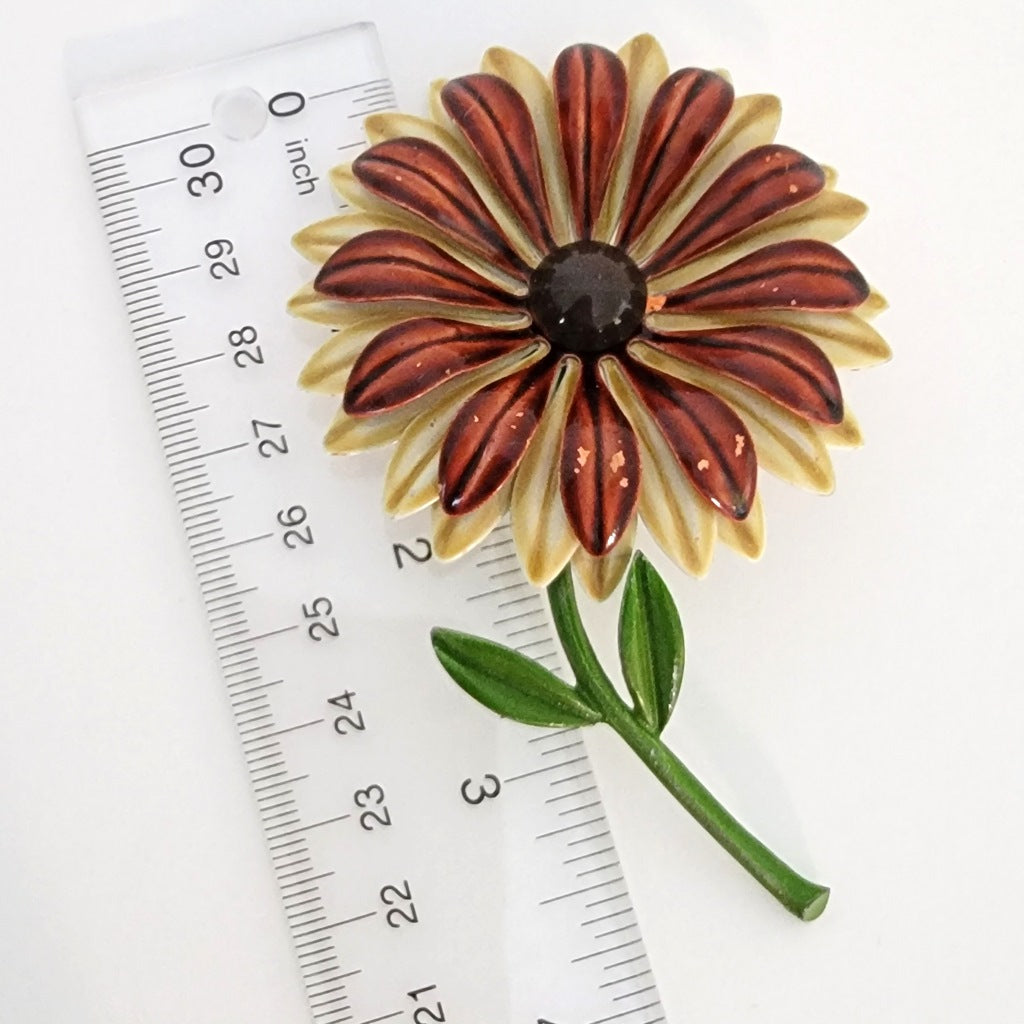 Big brown flower brooch with ruler.