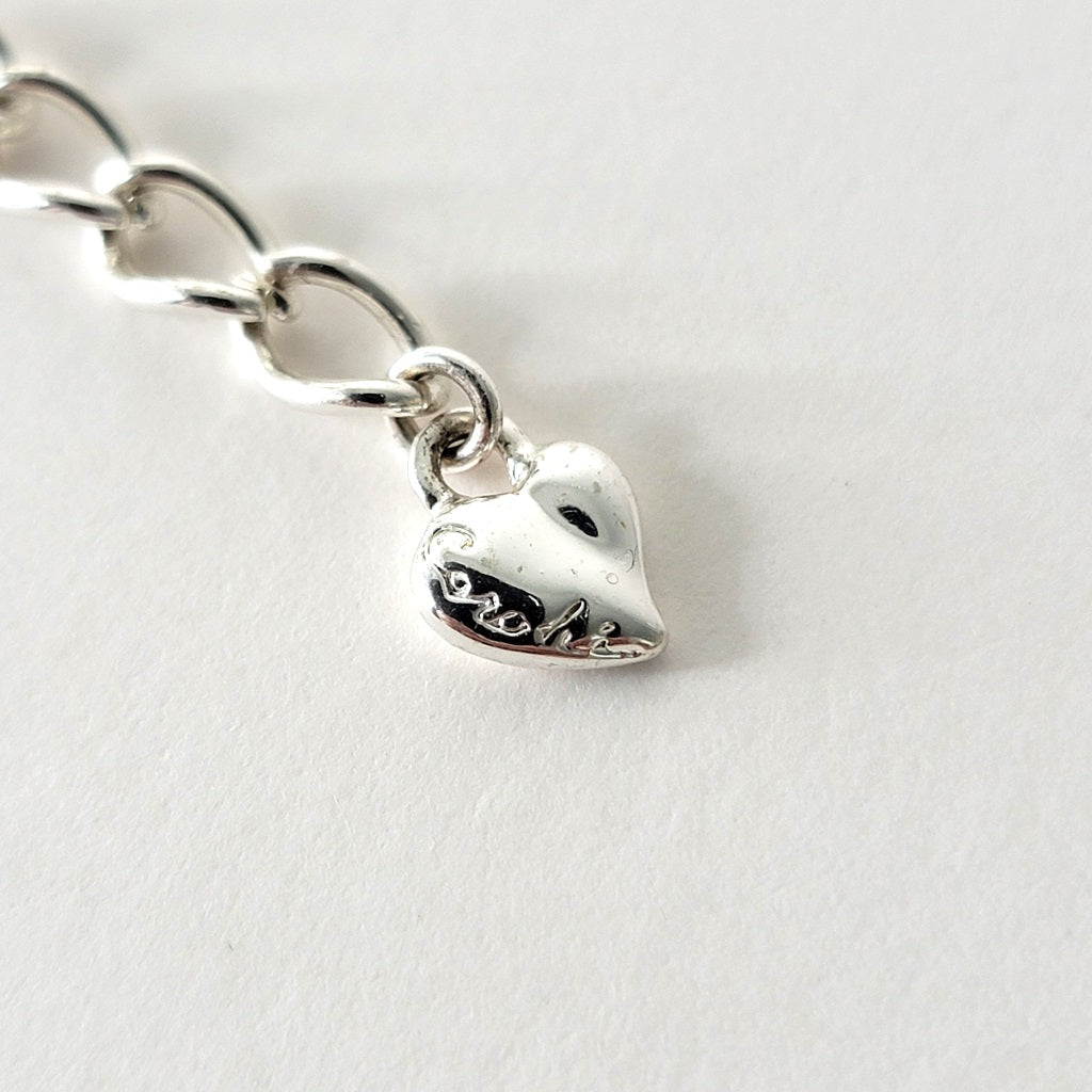 Carolee heart shaped signature tag.