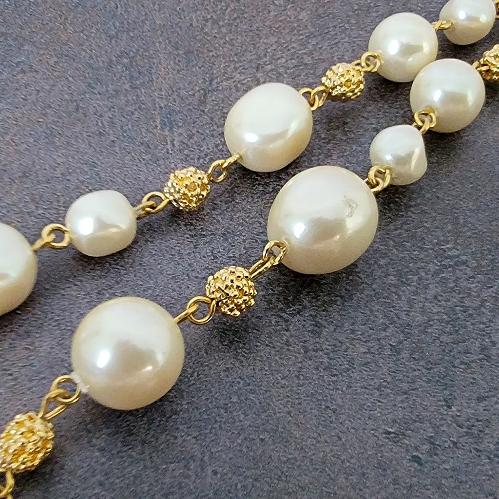 Faux pearl and gold tone beads.