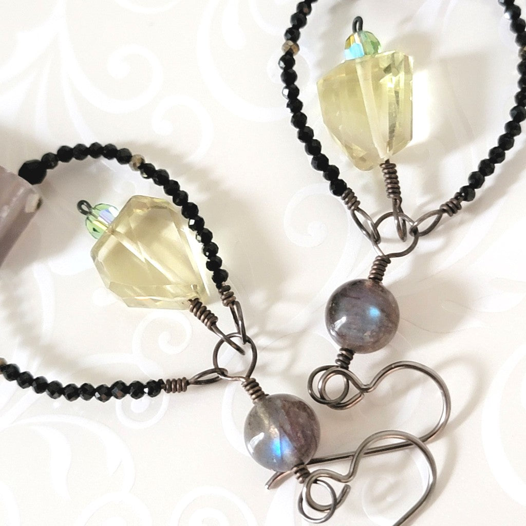 Close-up view of the blue flash in a pair of labradorite earrings.