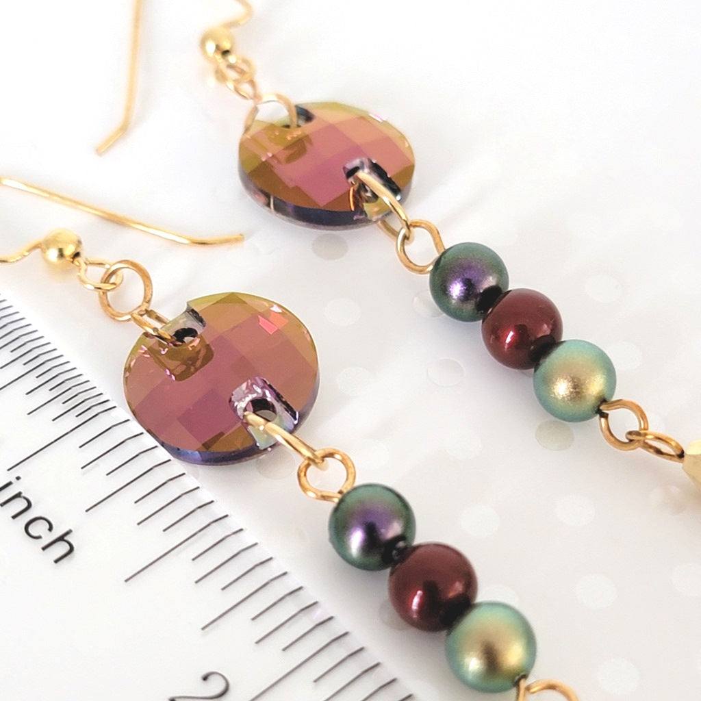 Faceted crystal and faux pearl beads, shown next to a ruler.