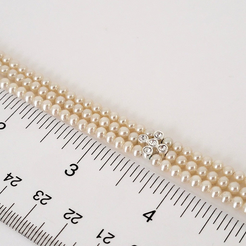 Faux pearl beads with a ruler.