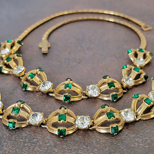 Vintage gold tone jewelry set with green and clear rhinestones.