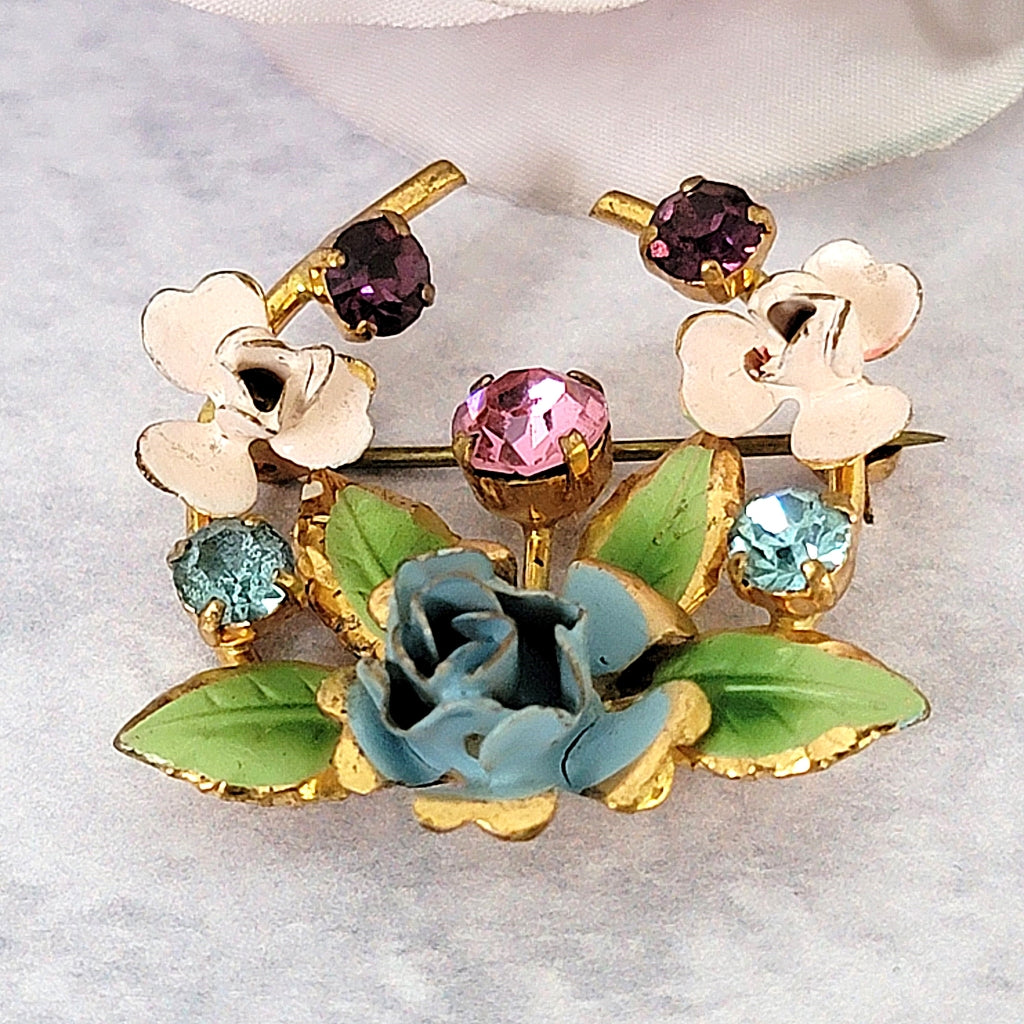 Vintage floral brooch with blue and pink enamel.