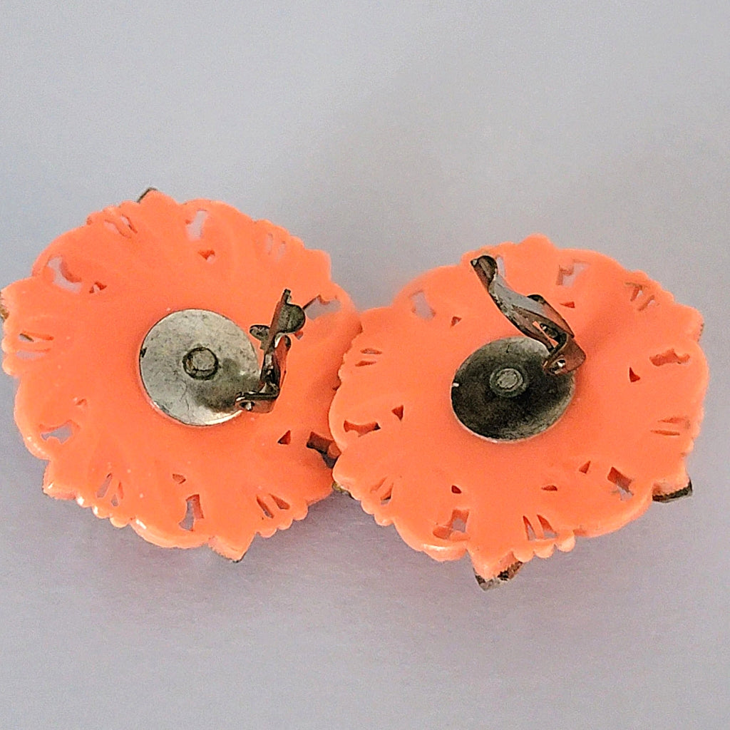 Back of coral plastic clip earrings.