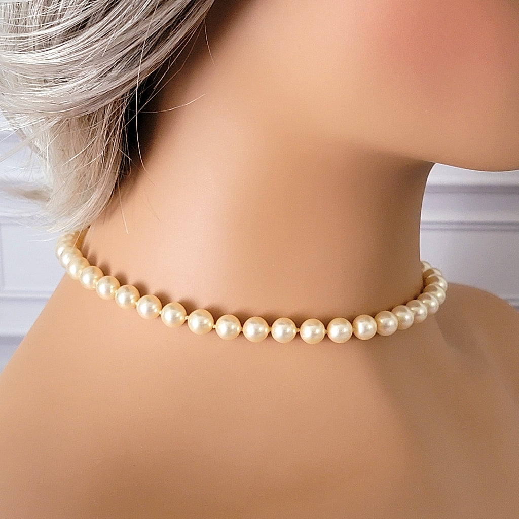 Vintage glass pearl choker on a mannequin.