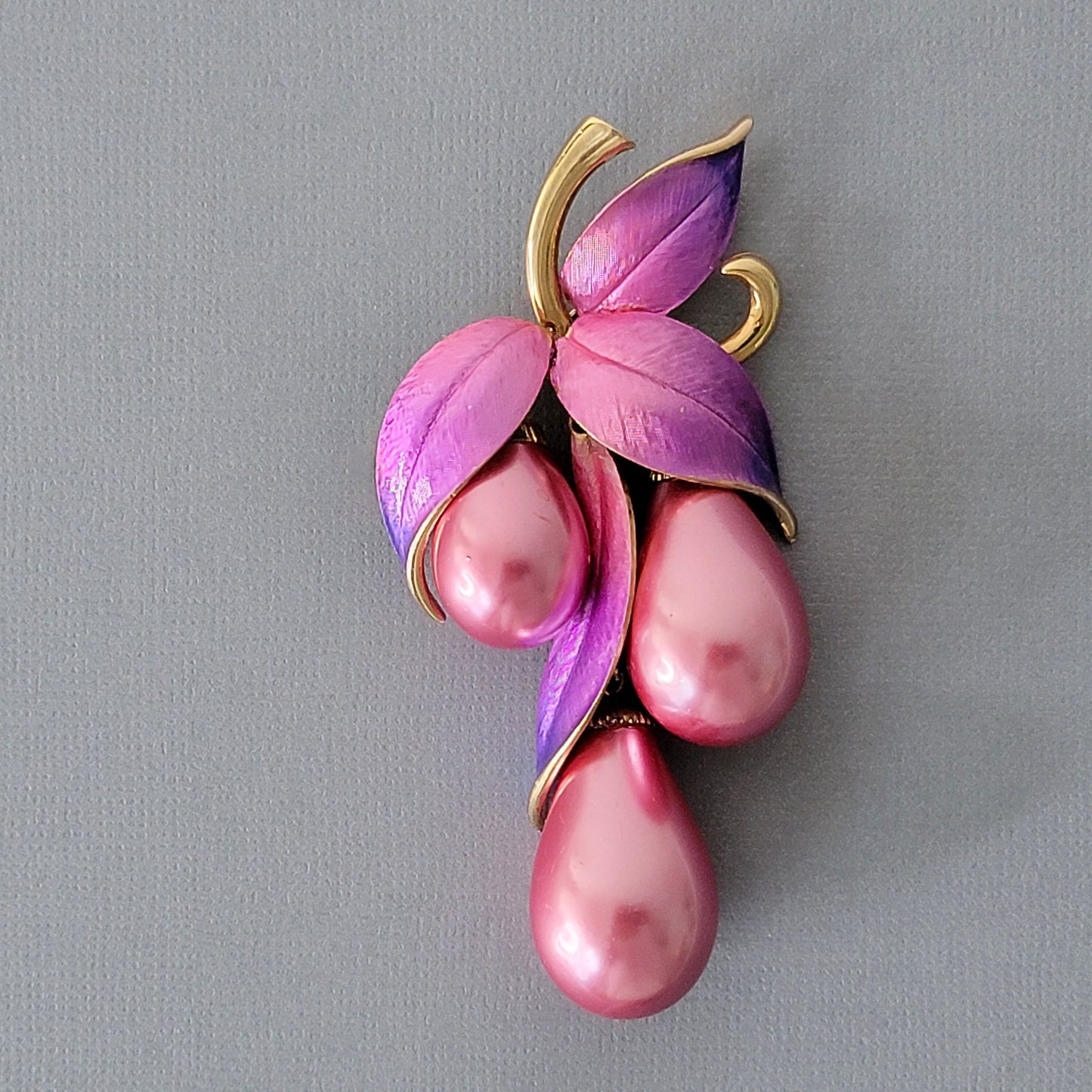 Large midcentury pink dangle fruit brooch with leaves.
