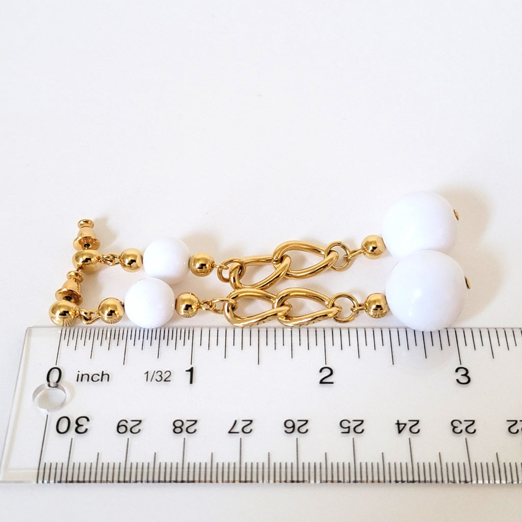Long white earrings with ruler.