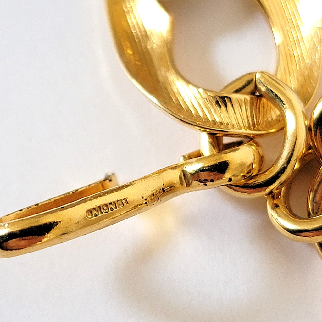 Monet signature mark on a necklace hook clasp.