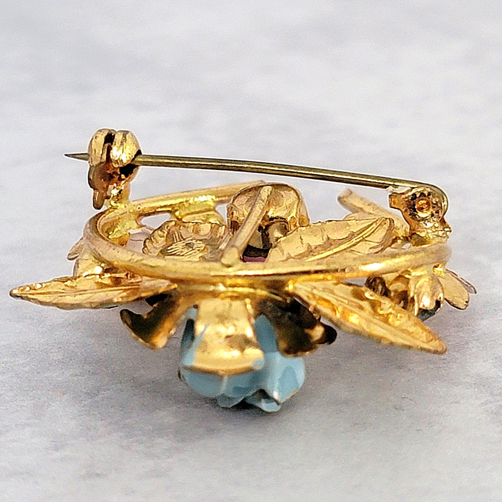 Pin stem and clasp on a vintage brooch.