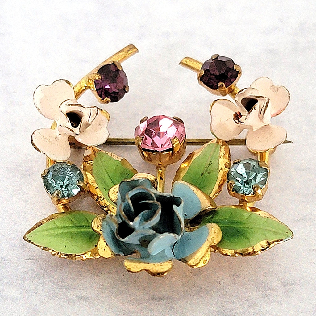 Vintage enamel floral brooch with multicolor crystals.