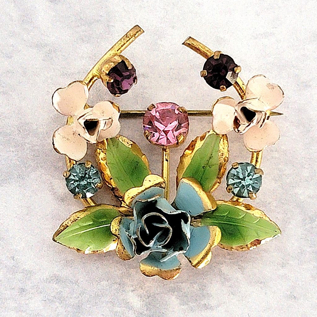 Vintage dainty enamel flower pin with rhinestones.