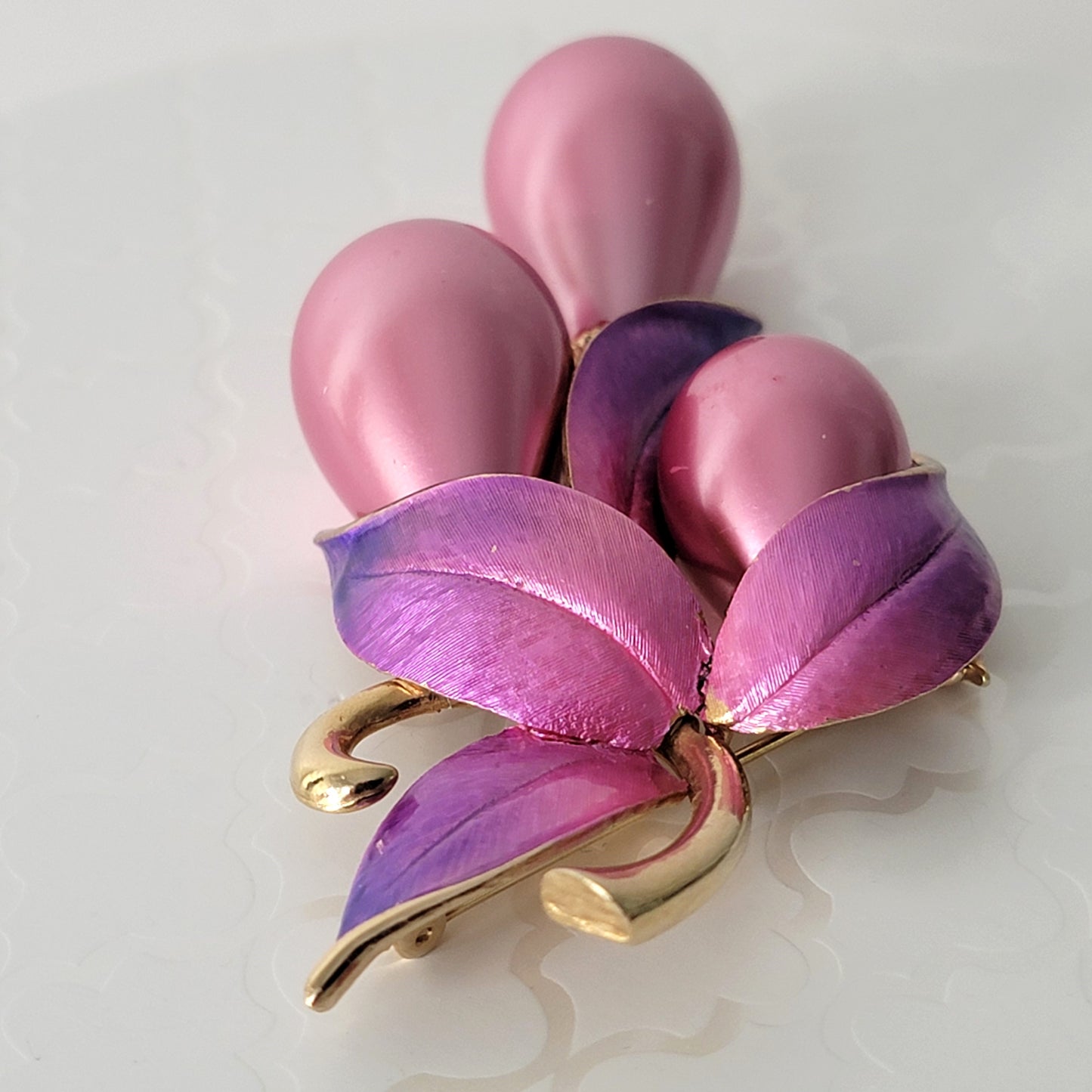 Pink to purple enamel detail on a vintage brooch.