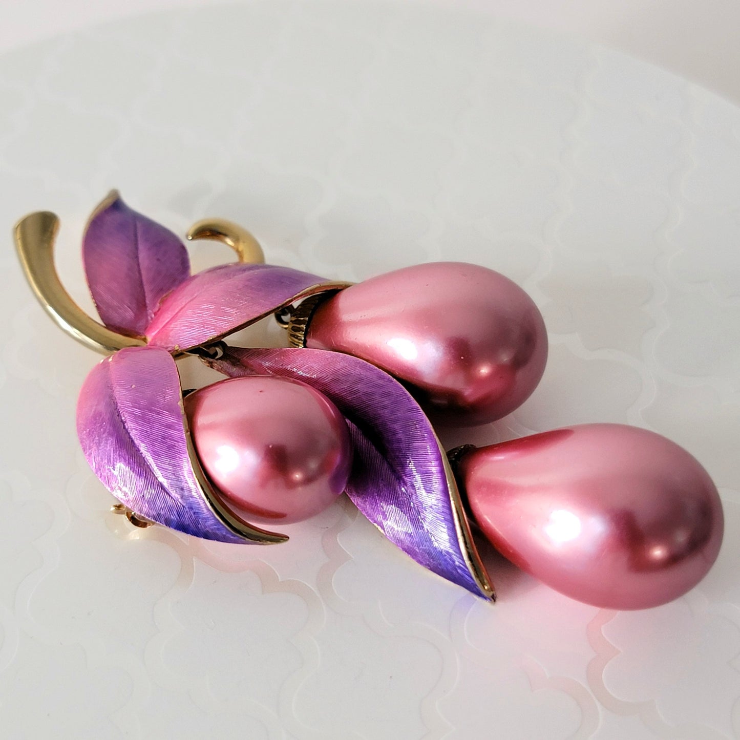 Pink vintage faux pearl pin with purple enamel leaves.