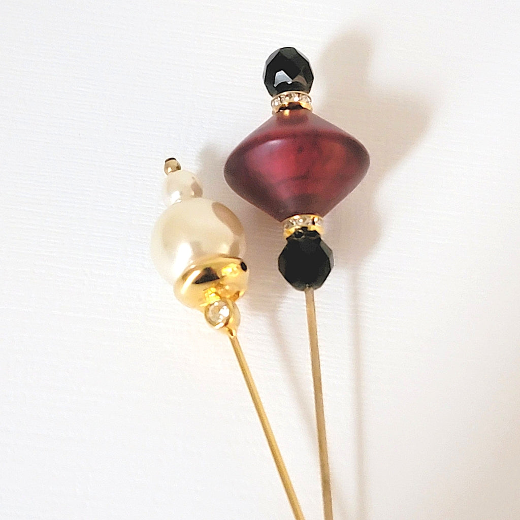 Two stick pin tops with faux pearls, red and black glass beads.