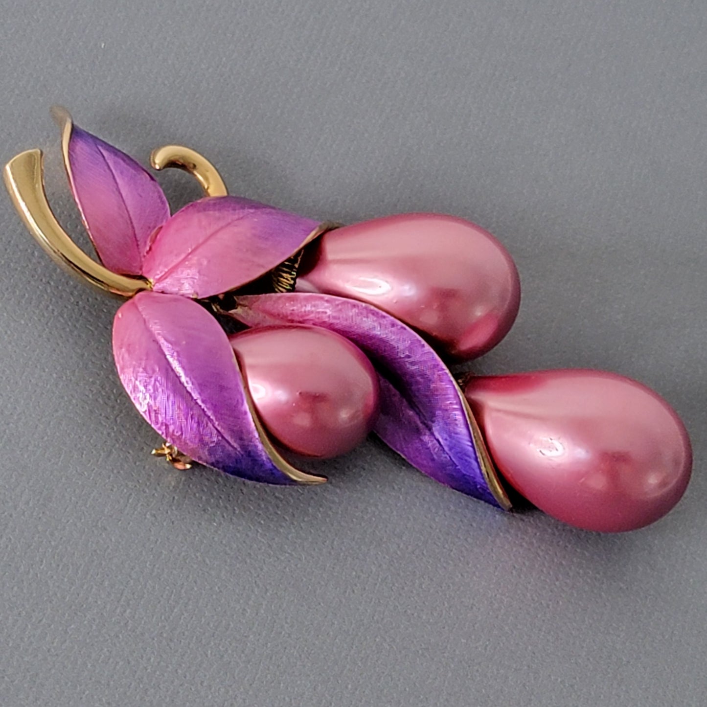 Detail of vintage pink pin with faux pearls.