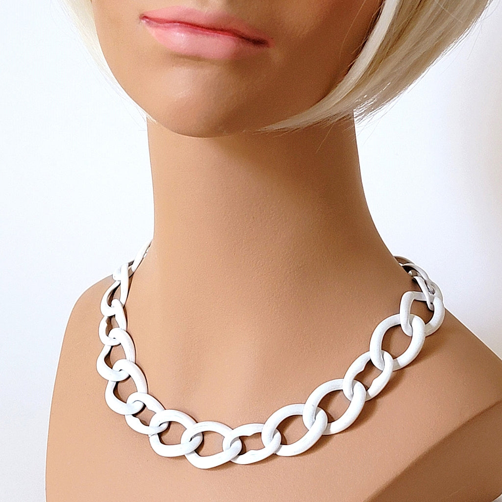 Vintage white enamel chain necklace on a mannequin.