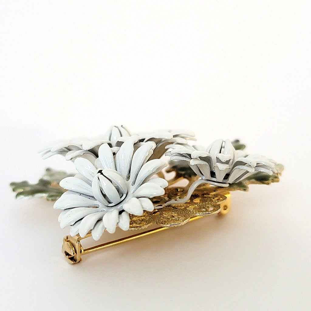 Top of an enamel flower pin.
