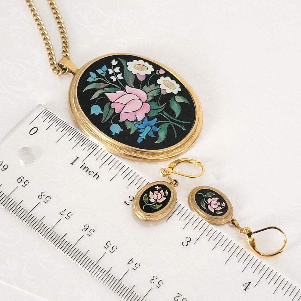 Avon floral necklace and earrings, next to a ruler.