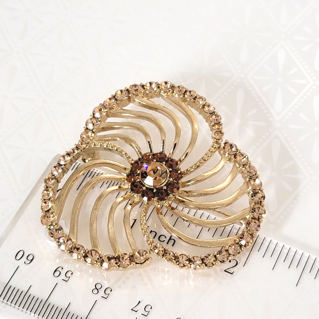 Lauren Conrad rhinestone brooch, next to a ruler.