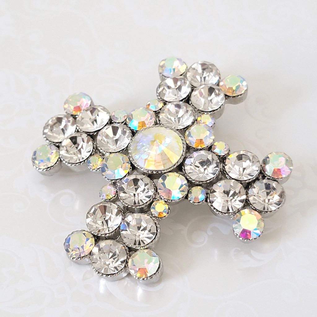 Large rhinestone cross pendant brooch, with clear and aurora borealis stones, in a silver tone setting.