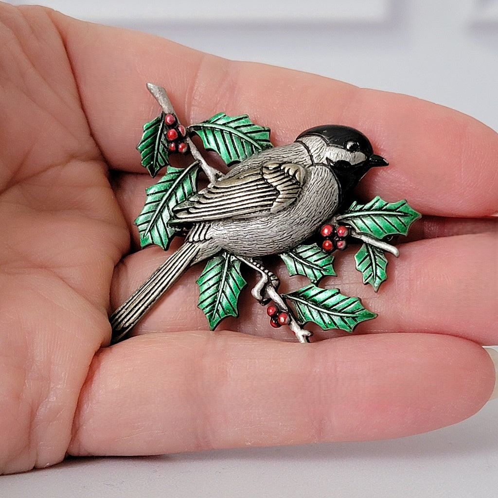Chickadee pin in hand.