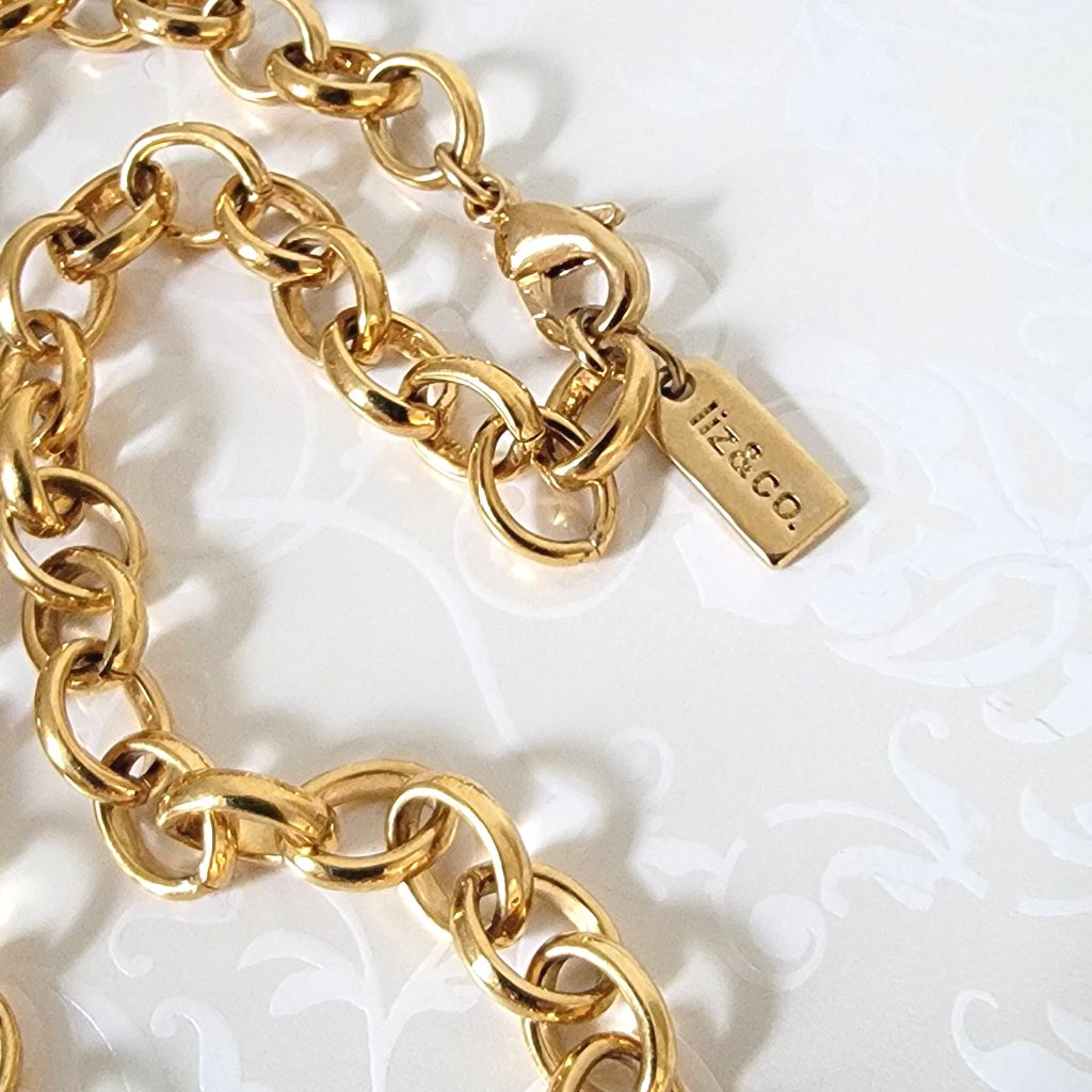 Closeup view of necklace clasp and Liz & Co. signature logo tag.