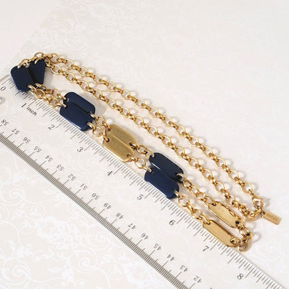 Liz & Co. gold tone and navy blue chain necklace, shown next to a ruler.