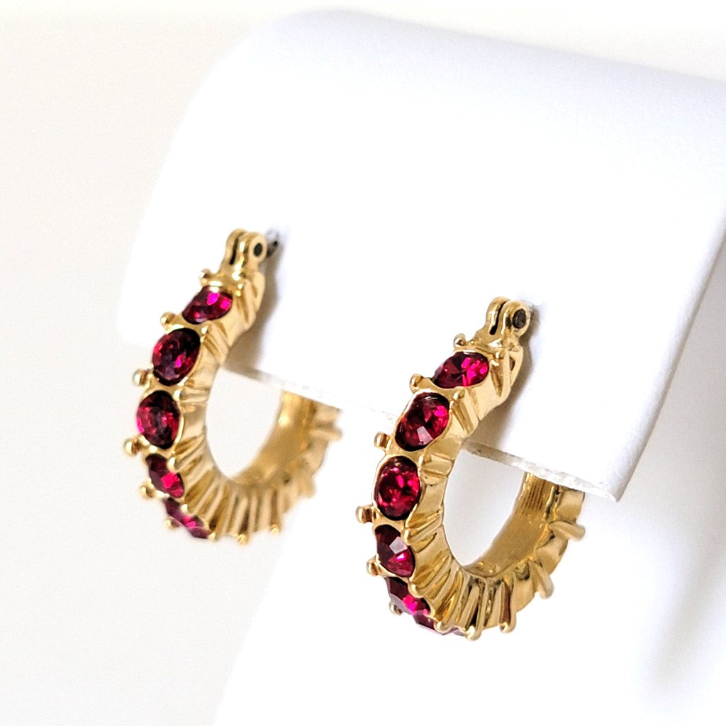 Napier red crystal rhinestone hoop earrings, in gold tone.
