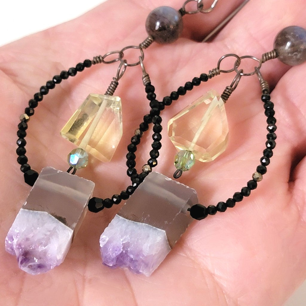 Amethyst, quartz and labradorite earrings, shown in hand, for size comparison.