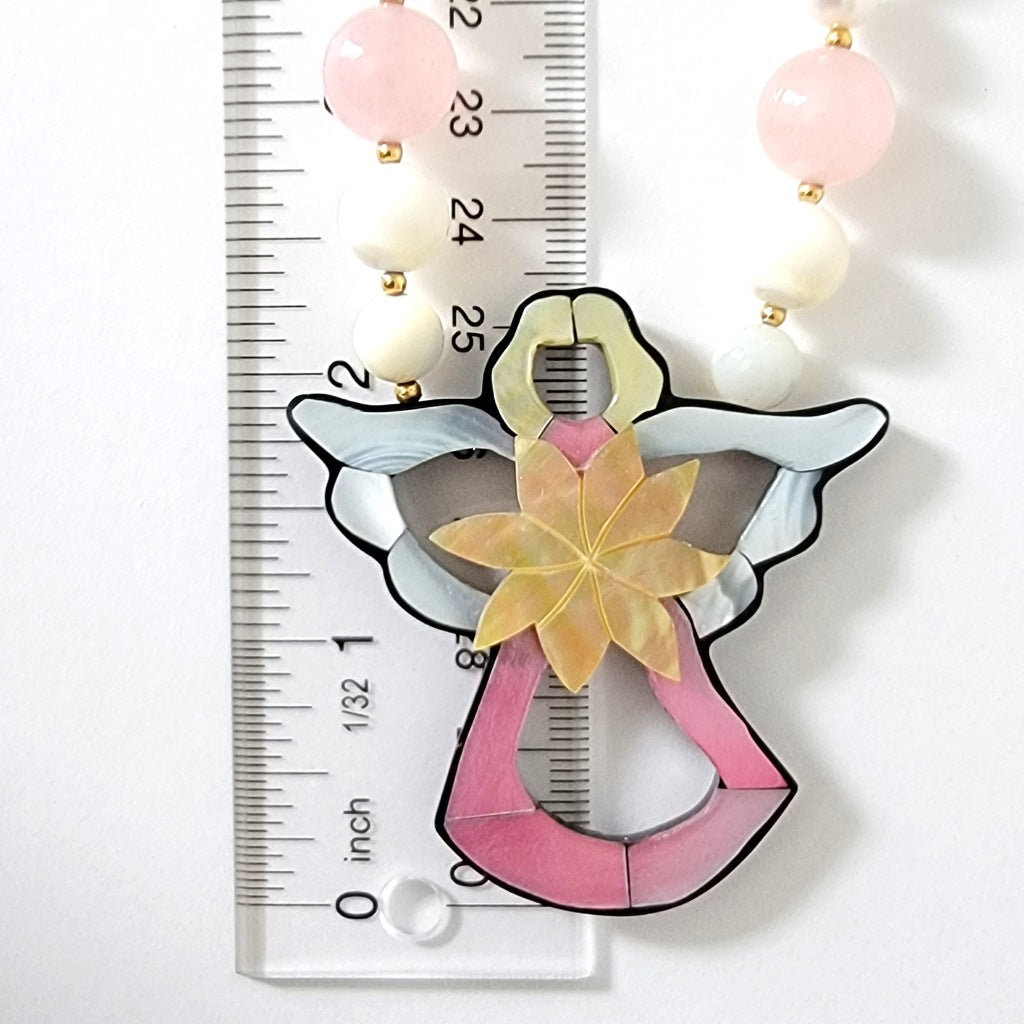 Angel pendant with ruler.