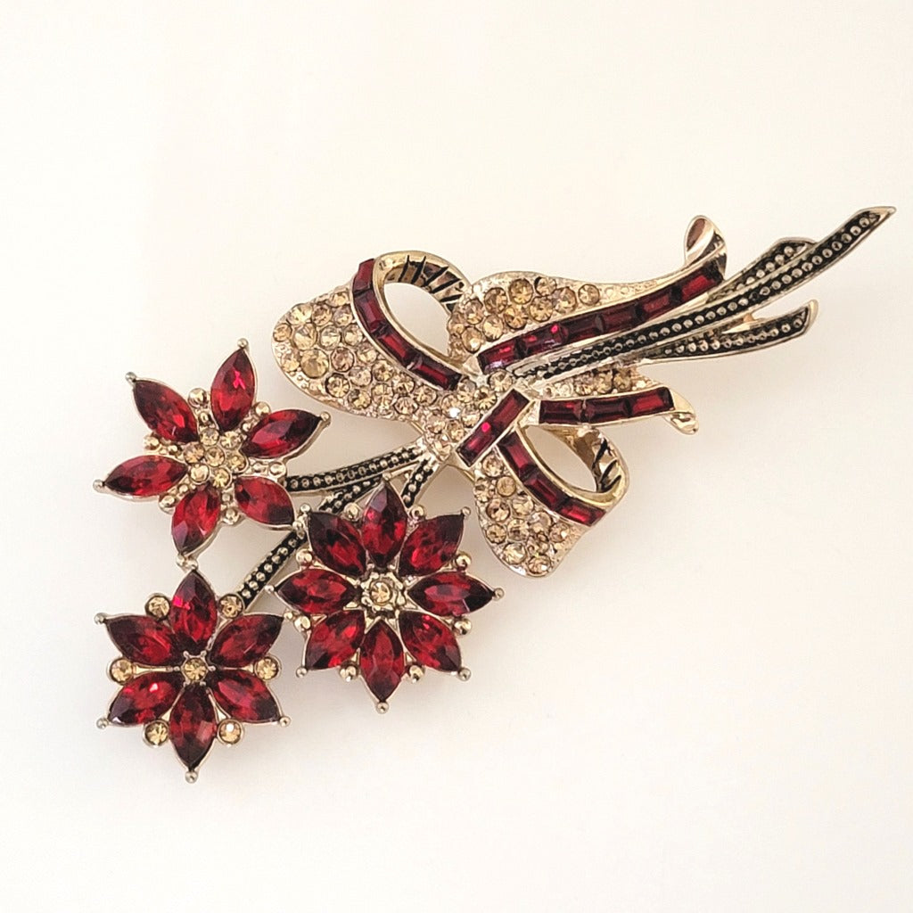 Red and gold rhinestone Christmas poinsettia brooch, by Avon.