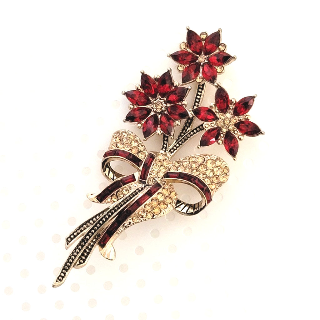 Avon rhinestone poinsettia Christmas brooch, a bouquet, tied with a bow.
