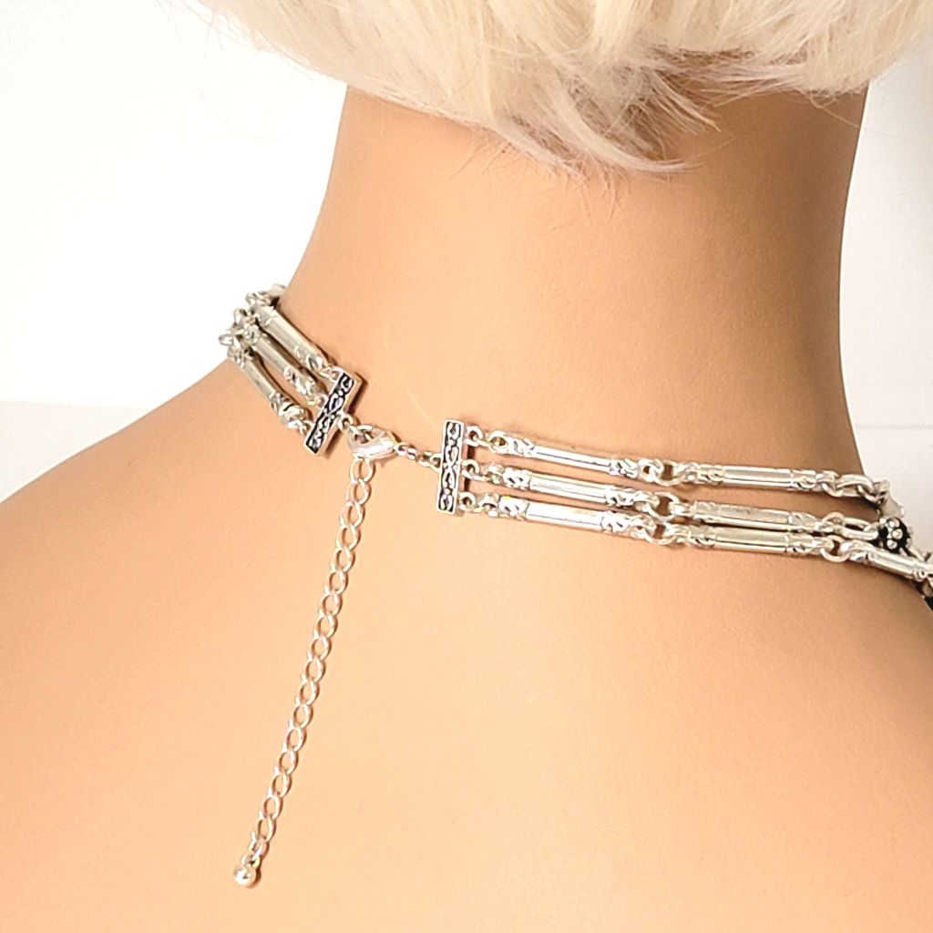 Avon three strand, silver tone necklace, back view, shown on a mannequin.