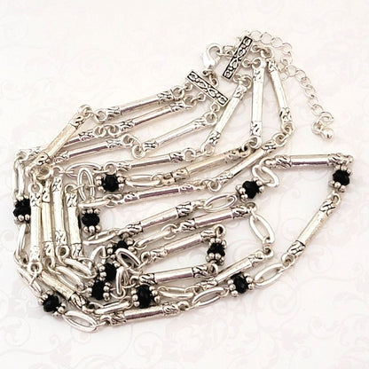 Avon three strand, antiqued silver tone necklace, with black bead accents.