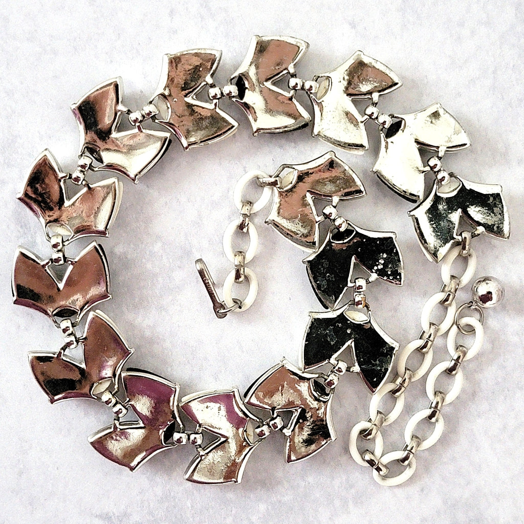 Silver tone back of necklace.