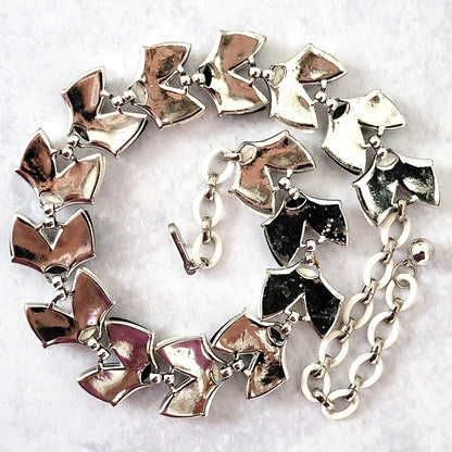 Silver tone back of necklace.