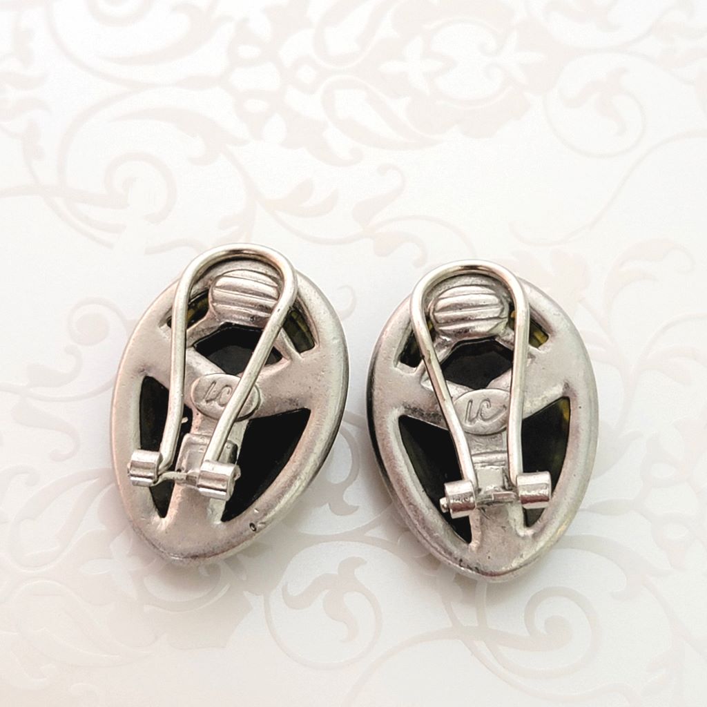 Back view of Liz Claiborne beetle earrings, showing clips and signature marks.