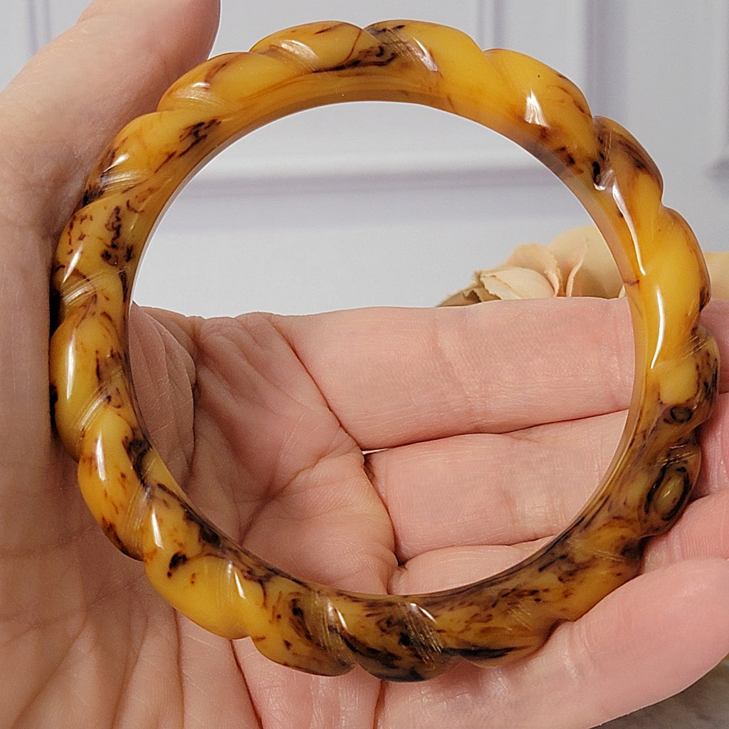 Vintage Bakelite bracelet in hand.