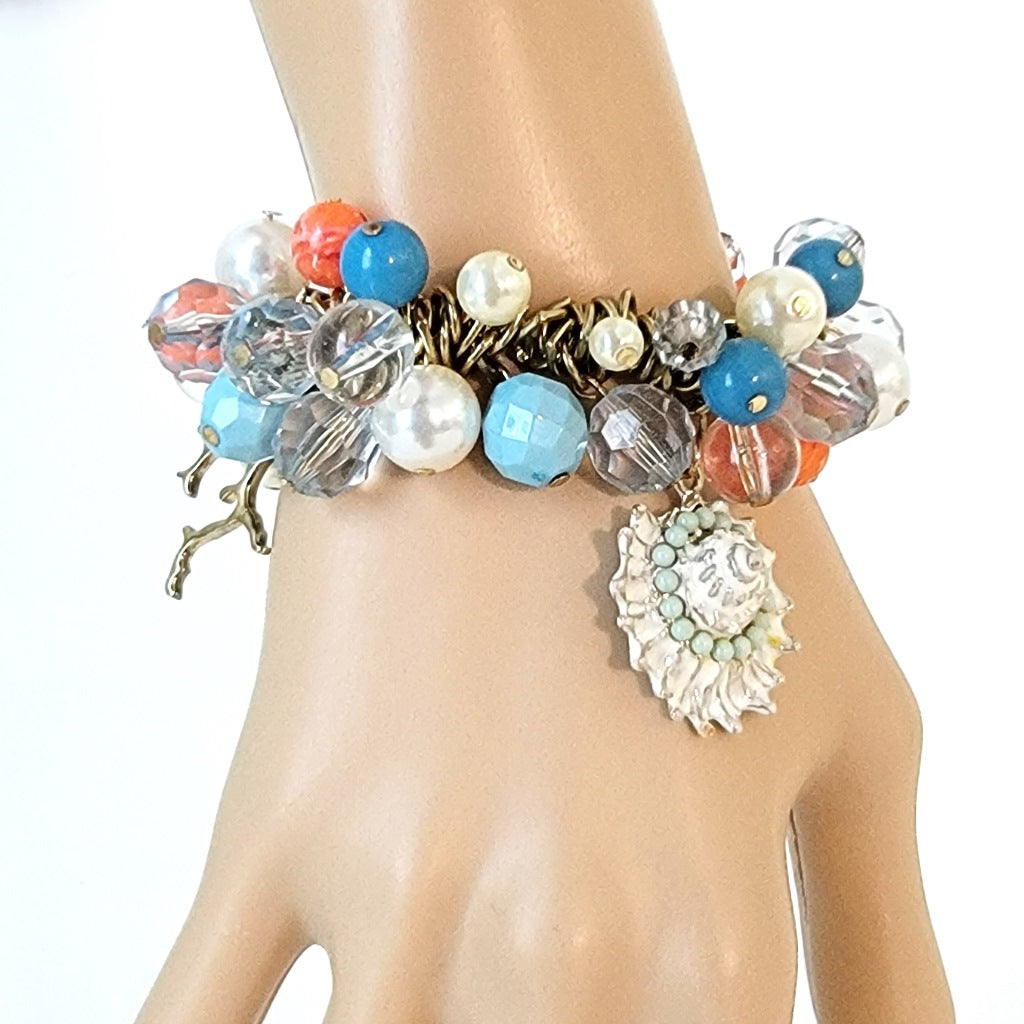 Shell and bead bracelet on wrist.