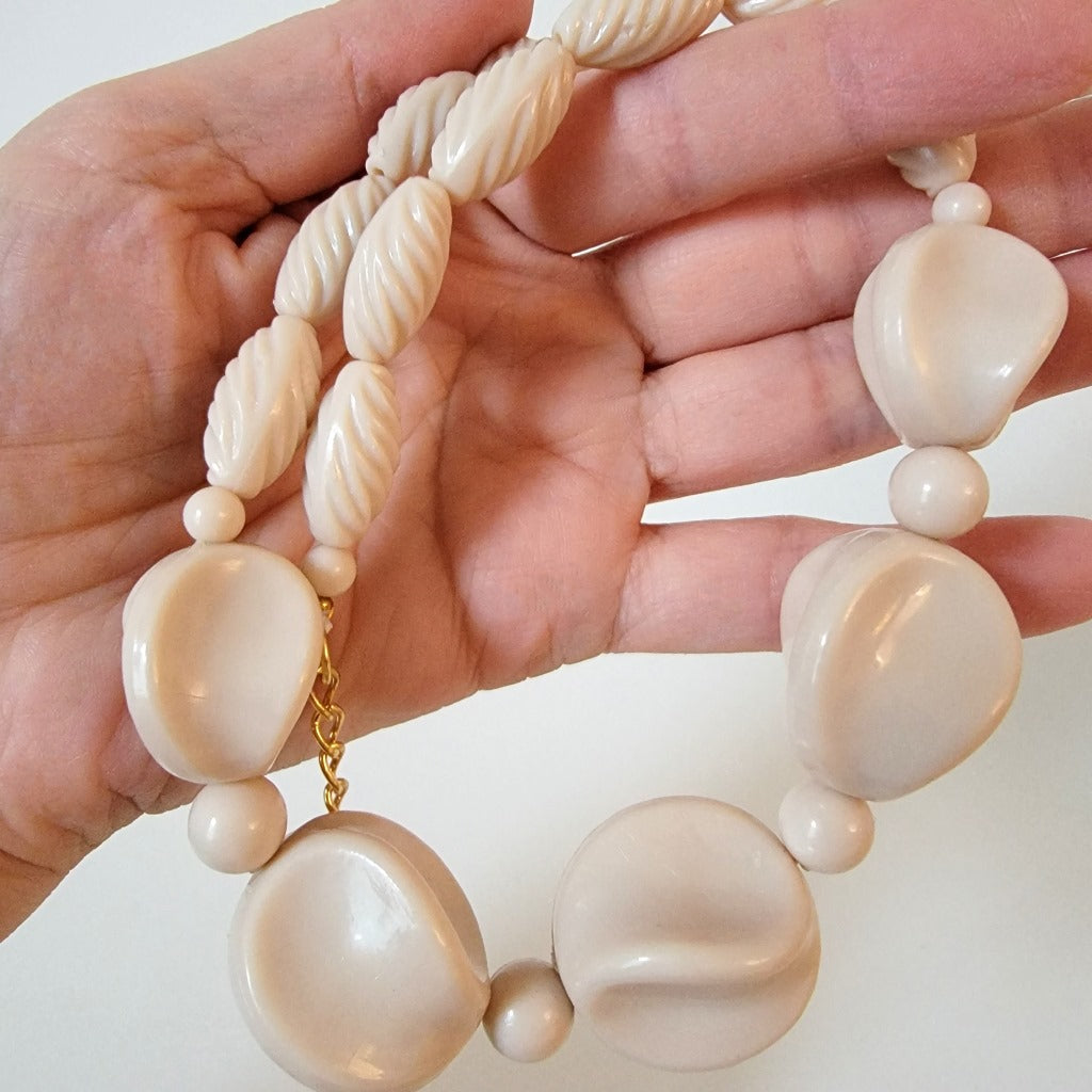 Chunky necklace in hand.