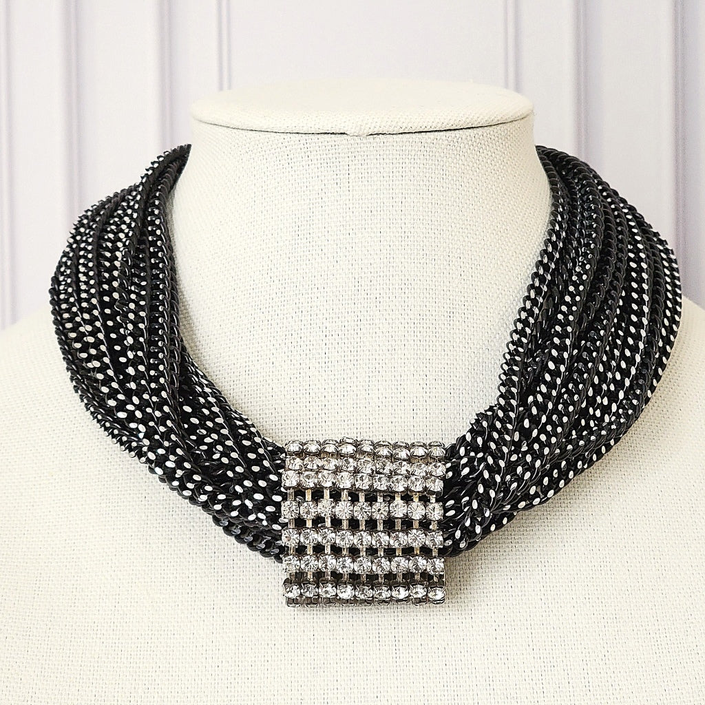 Black multistrand choker necklace.