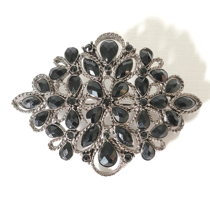 Monet black rhinestone brooch.