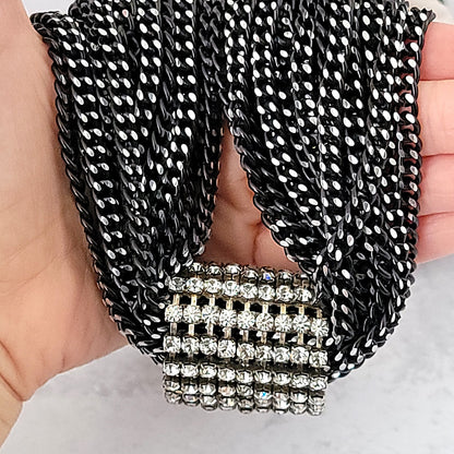 Black aluminum chains with a rhinestone focal enhancer.
